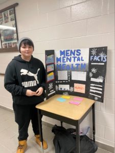 Student posting in front of booth at Chill Fair